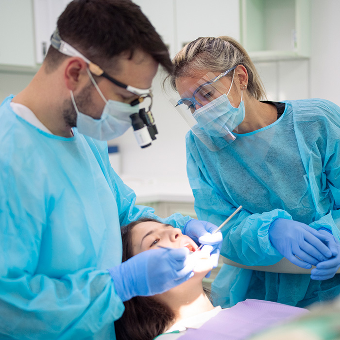 People performing a dental procedure
